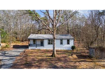 Charming single-story home with a cozy front porch and well-maintained landscaping at 3192 Highway 411 Ne, White, GA 30184