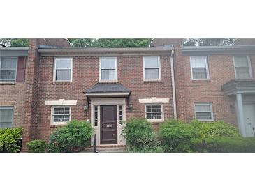 Charming brick townhome featuring a covered entryway and well-maintained landscaping at 3307 York Pl, Decatur, GA 30032
