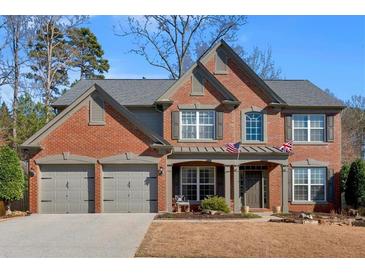 Charming two-story brick home with a well-manicured lawn and a three-car garage at 510 Pinchot Way, Woodstock, GA 30188
