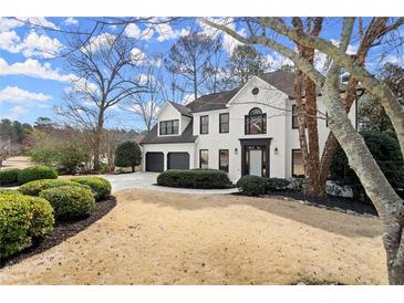 Charming two-story home with a white brick exterior, manicured landscaping, and a two-car garage at 6268 Braidwood Nw Run, Acworth, GA 30101