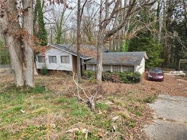 Charming one-story home featuring a classic design and mature trees at 4028 William Mary Ct, Decatur, GA 30034