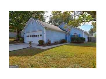 Charming single-Gathering home with attached garage, well-maintained lawn, and mature trees in a quiet neighborhood at 1241 Larkwood Dr, Jonesboro, GA 30238
