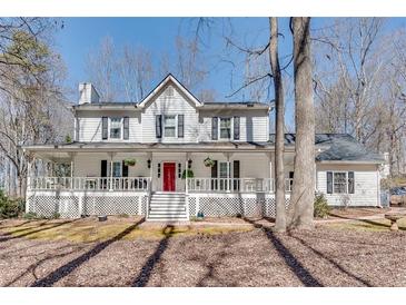 Charming two-story home with a welcoming front porch and beautiful landscaping at 2825 Parnell Springs Ct, Cumming, GA 30040