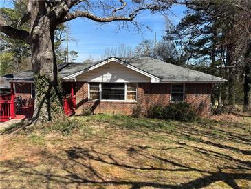 Charming one story brick home with a covered porch and mature trees offering shade at 496 Elizabeth Sw Ln, Mableton, GA 30126