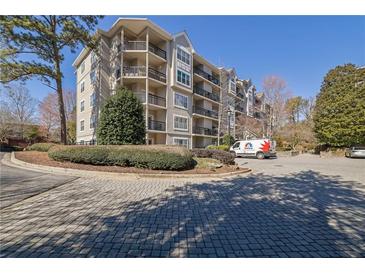 Beautiful condo complex with brick driveway and mature landscaping at 1406 River Green Nw Dr, Atlanta, GA 30327