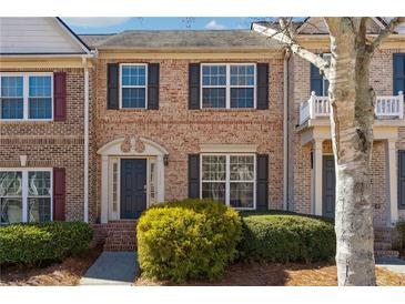 Charming brick townhome with manicured landscaping and classic architectural details at 4550 Cold Spring Ct, Cumming, GA 30041