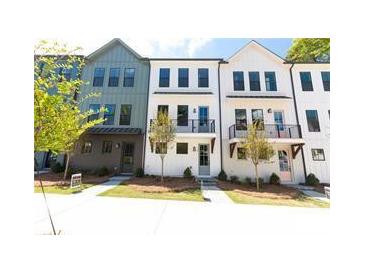 Row of modern townhomes featuring varied colors, small balconies, and well-kept lawns at 507 Zeal Street # 334, Atlanta, GA 30315