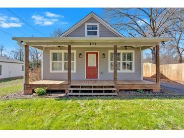 Cozy front porch with ceiling fans and wood columns, perfect for relaxing and enjoying the outdoors at 172 4Th St, Emerson, GA 30137