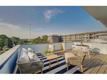Relaxing rooftop patio with modern furniture and neighborhood view on a sunny day at 816 Berne St # 4, Atlanta, GA 30316