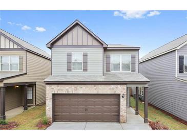 Charming two-story home with a brick-accented garage and inviting curb appeal in a well-maintained neighborhood at 326 Lauren Dr, Fairburn, GA 30213
