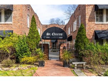 Charming brick building entrance with elegant landscaping and covered entryway at 1026 Saint Charles Ne Ave # 10, Atlanta, GA 30306