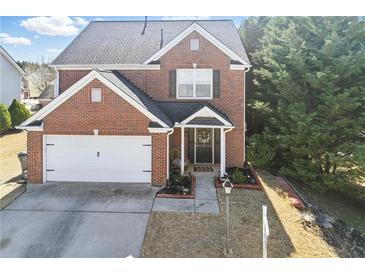 Inviting two-story brick home with a well-manicured lawn and attached two-car garage at 1039 Bramble Way, Grayson, GA 30017
