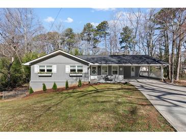 Charming single story home with grey siding, a covered carport, and a well-maintained lawn at 1300 Valley Ct, Roswell, GA 30075