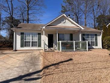 Charming single-story home with neutral siding, large windows, and a cozy front porch at 6163 Princeton Ave, Morrow, GA 30260