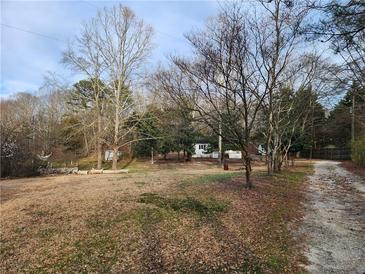 Charming home nestled in a wooded area, surrounded by mature trees offering privacy at 1619 Flowery Branch Rd, Auburn, GA 30011