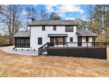 Back exterior view showing a modern two-story house with a large deck at 260 Sandy Lake Cir, Fayetteville, GA 30214