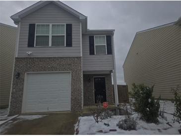 Two-story home featuring a garage, gray siding, and black shutters at 2087 Belmont Cir, Conyers, GA 30012