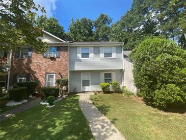 Charming townhome featuring a well-manicured front lawn and inviting walkway at 6104 Cobblestone Ct, Douglasville, GA 30134