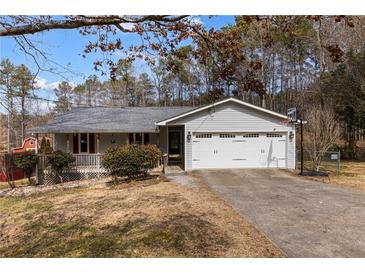 Charming one-story home with a two-car garage, basketball hoop, and partially covered front porch at 3521 Stone Ridge Dr, Douglasville, GA 30134