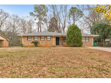 Charming brick home featuring well-maintained landscaping and a welcoming entrance at 3783 Brookcrest Cir, Decatur, GA 30032