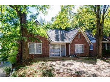 Charming brick home featuring large windows and mature trees in a peaceful neighborhood at 17 Peachtree Ne Ave, Atlanta, GA 30305