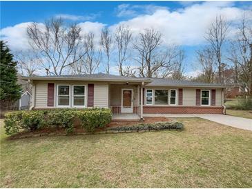 Charming single-story home with tan siding, red shutters, brick accents, and a well-maintained front yard at 1793 Witt Cir, Austell, GA 30168