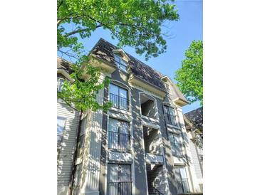 Beautiful condominium building with balcony, and multiple windows and lovely architecture and surrounded by trees at 2657 Lenox Ne Rd # 29-1, Atlanta, GA 30324