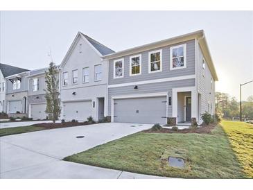 New construction townhomes showcasing craftsman-style architecture with gray and white color schemes and manicured lawns at 221 Admor Ln, Acworth, GA 30102