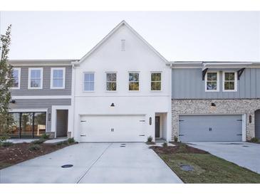 Newly constructed townhomes with a mix of painted brick and siding exteriors, complemented by well-maintained lawns at 205 Admor Ln, Acworth, GA 30102