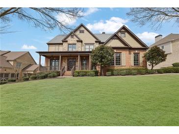 Charming two-story home with a covered front porch, landscaped yard, and a well-manicured lawn at 3060 Salisbury Ln, Cumming, GA 30041