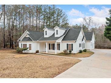 Charming home featuring white siding, black shutters, dormers and a long driveway at 279 Scarborough Rd, Stockbridge, GA 30281