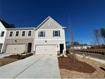 Two-story home with attached garage, neutral siding, and well-maintained landscaping, offering curb appeal at 417 Carrera Ln, Acworth, GA 30102