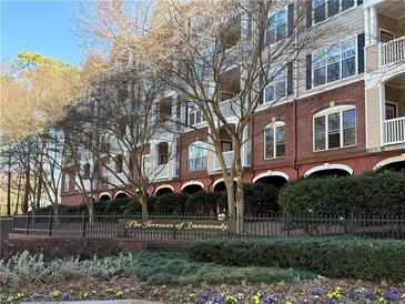 View of the exterior of The Terraces of Turnwoody condominium complex, with beautiful landscaping at 4333 Dunwoody Park # 1202, Atlanta, GA 30338