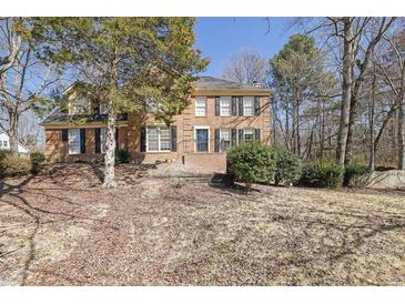 Traditional brick home featuring black shutters and a well-manicured lawn at 3109 Wynford Gables Sw, Marietta, GA 30064