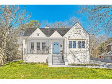 Charming white home with a lovely front porch and a well-manicured lawn at 1337 M L King Jr Nw Dr, Atlanta, GA 30314