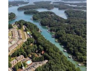 Scenic aerial view showcases the waterfront property with lush greenery and stunning lake views at 2075 Pine Tree Dr, Buford, GA 30518