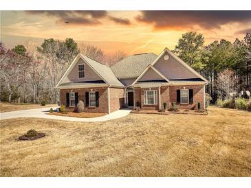 Beautiful brick home with well-manicured lawn and inviting entrance, perfect for a Gathering at 75 Horseshoe Dr, Covington, GA 30014