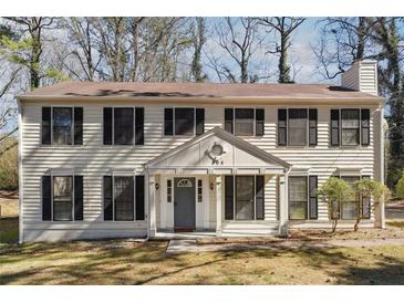 Charming two-story home with a classic white facade, black shutters, and a welcoming front porch at 505 S Malton S Ct, Stone Mountain, GA 30083