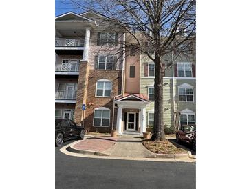 Charming condo building with well-maintained landscaping and inviting entryway at 1965 Nocturne Dr # 1103, Alpharetta, GA 30009