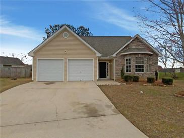 Charming single-Gathering home with stone accents, a two-car garage, and a well-maintained lawn at 40 Zebulon Pl, Covington, GA 30016