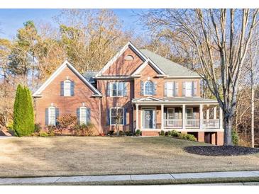 Charming brick two-story home boasts a manicured lawn and inviting front porch at 4330 Old Oak Trce, Cumming, GA 30041