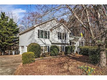 Charming two-story home with well-maintained landscaping, mature trees, and a welcoming front entrance at 2033 Old Newnan Rd, Carrollton, GA 30116