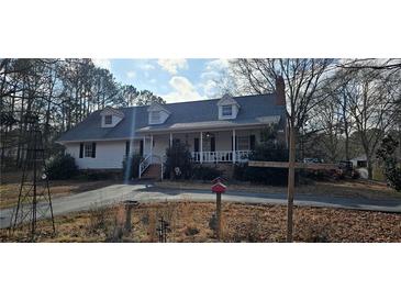 Charming single-Gathering home featuring a welcoming front porch, dormer windows, and a well-maintained lawn at 3640 Chandler Haulk Rd, Loganville, GA 30052