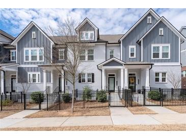Charming townhome exterior featuring a well-manicured lawn and inviting front porches at 2740 Bell Se Dr, Smyrna, GA 30080