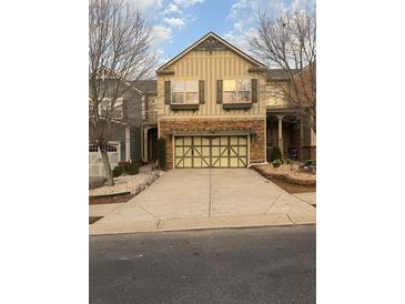 Charming two-story home with a two-car garage and an inviting stone facade and well-maintained driveway at 2530 Gold Creek Ln, Cumming, GA 30041