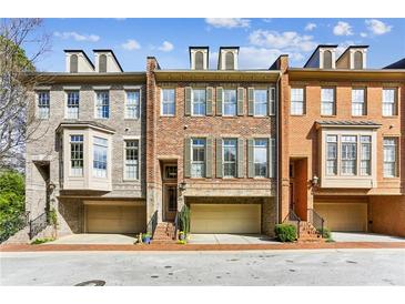 Charming townhome with brick facade, dormers, and attached garages in a well-maintained community at 4 Candler Grove Dr, Decatur, GA 30030