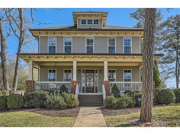 Charming two-story home featuring a welcoming front porch with white columns and landscaped yard at 2987 Jefferson St, Atlanta, GA 30341