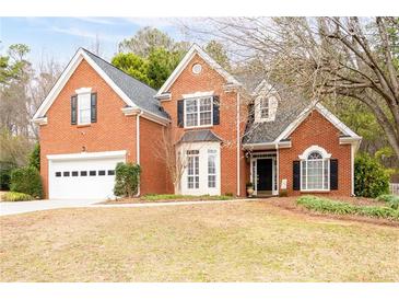Charming two-story brick home with a well-maintained lawn and attached two-car garage at 5952 Edenfield Nw Dr, Acworth, GA 30101