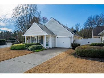 Charming single-story home with manicured lawn and attached two-car garage at 1905 Cottage Grove Way, Cumming, GA 30040