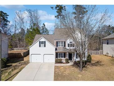 Charming two-story home featuring a two car garage and manicured lawn at 5729 Newnan Cir, Austell, GA 30106